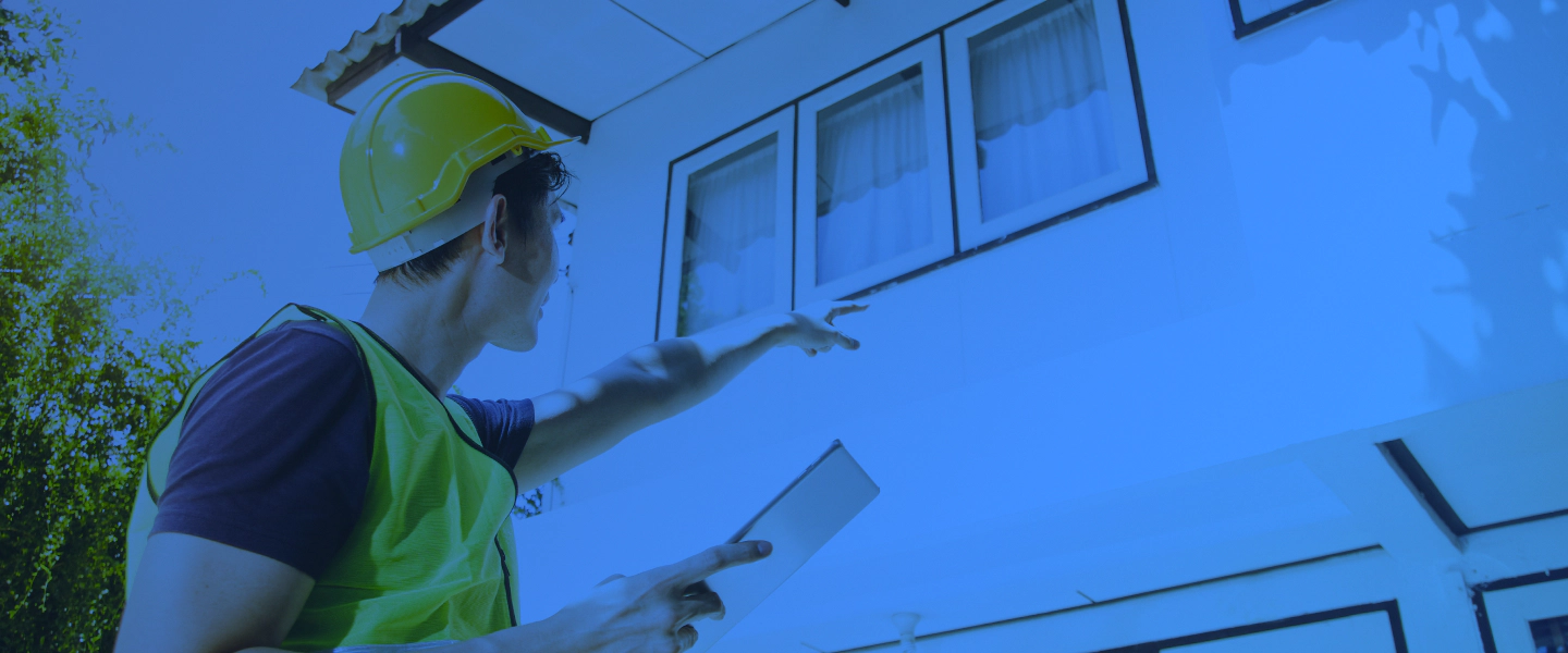 man with clipboard pointing at a house SUPPLY NC